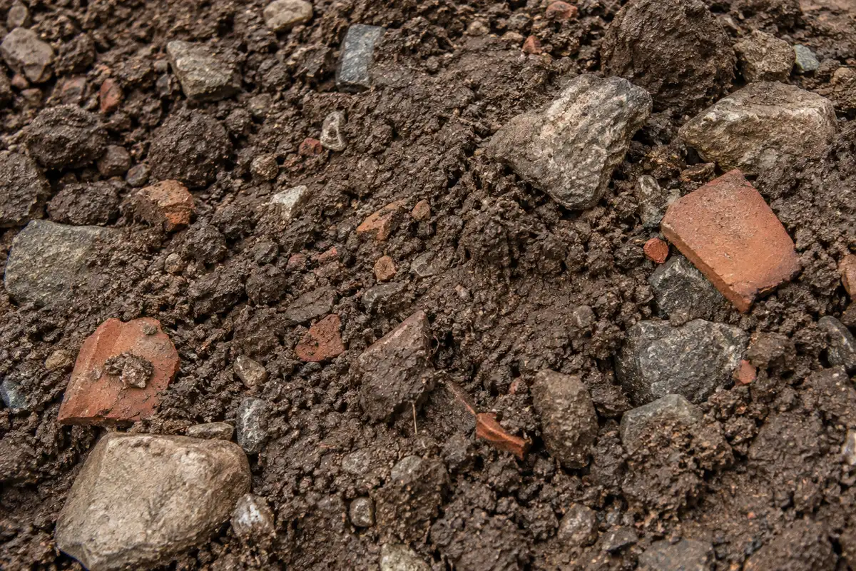 Illustrative close-up of clean fill: soil, rocks and broken brick